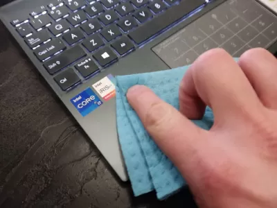 How To Remove Stickers On Laptop? : Removing stickers on laptop using a damp cloth